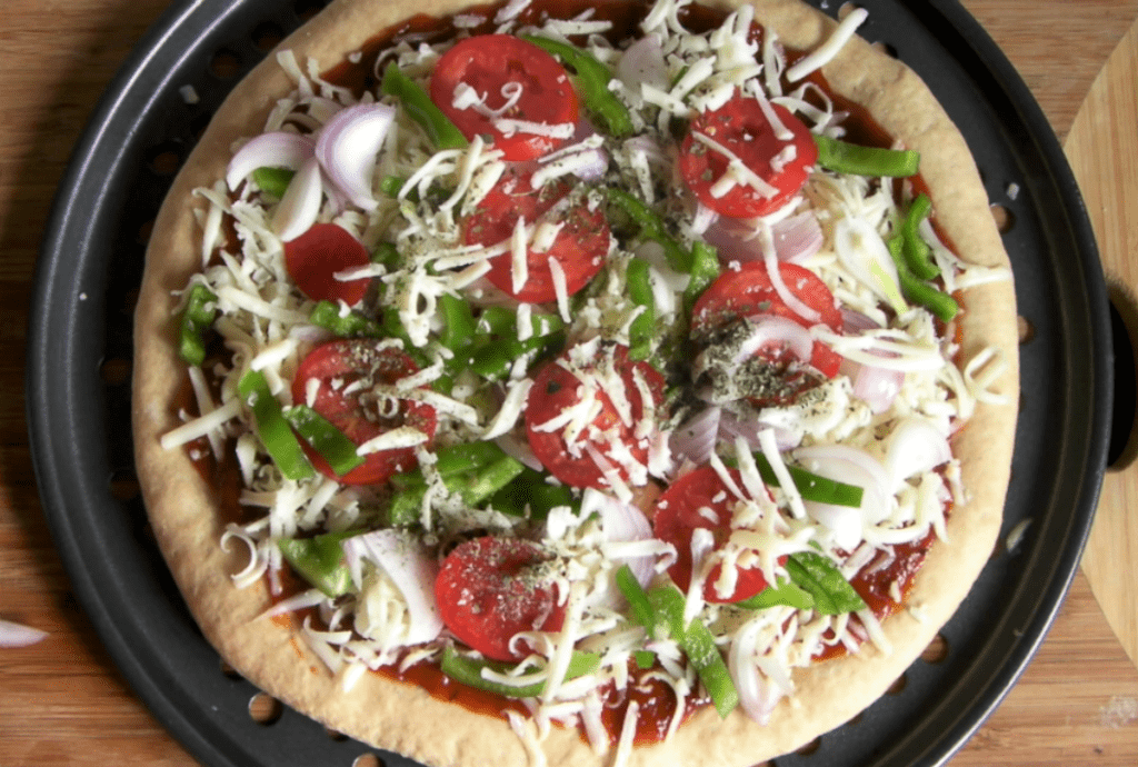 Whole wheat veggie pizza made with yeast from scratch